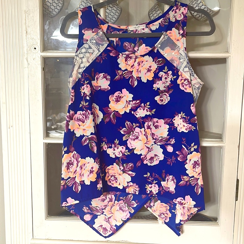 Floral tank with lace accents and crisscross back.